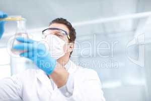 Lets see what happens. Low angle shot of a chemist mixing chemicals.