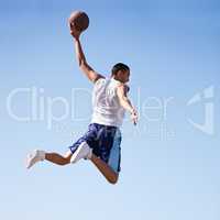 Defying gravity. A young athlete taking a flying jump.