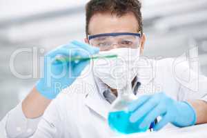 Dangerous experiment. Closeup of a chemist pouring two chemicals together.