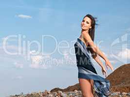 Free to be me. Shot of a beautiful young woman draped in a sarong blowing in the wind.