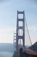 Marvels of civil engineering. A large suspension bridge across the water on a sunny afternoon.