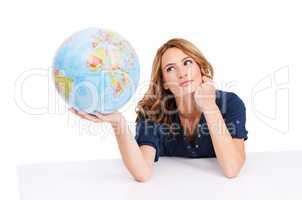 The world is big place, so where should I go next - Travel Tourism. An inquisitive young beauty holding a globe of the Earth with Africa facing the camera.