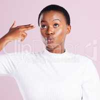 Lifes too short to not be weird. Studio shot of a young woman holding up a finger gun gesture against a pink background.