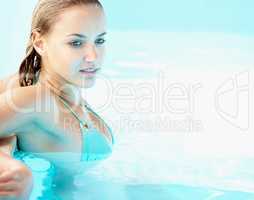 Thoughtful young female in a swimming pool. Contemplative young woman in a swimming pool , room to paste your text.