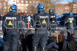 Ready for anything. Rearview shot of a police man in riot gear.