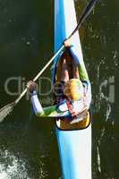 Just go with the flow.... A high angle shot of a man canoeing down a river.