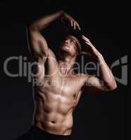 I can tell you why to exercise, but Id rather show you. Shot of a muscular young man posing against a black background.