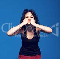 Frustration. Studio portrait of a young woman pressing her fists against her face.