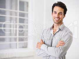Confidence is infectious. Portrait of a smiling handsome man with his arms crossed.