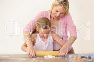 Learning to bake biscuits. A mother showing her daughter how to bake.