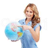 Theres so much to explore - Travel Tourism. A pretty young woman pointing to the East Coast of North America on a world globe.