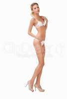 Statuesque. Full-body of of a gorgeous blond woman standing while isolated on a white background.