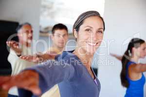 Positive outlook on health. A group of people taking a class together at gym.