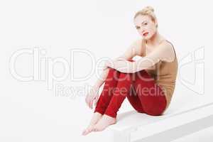 Casual beauty. Portrait of a beautiful blonde wearing casual clothing sitting in a studio.