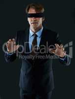 Wandering blindly through the business world. Cropped shot of a blindfolded businessman.