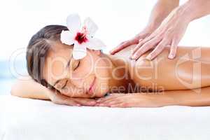 Lost in spa bliss. Gorgeous young woman relaxing during a spa massage.