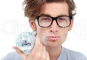 Hes in charge of the party. Handsome young man pouting and holding a small disco ball.