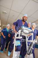 Its go time. Shot of a medical team rushing through a hospital corridor.