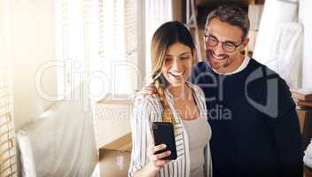 Lets show everyone our new place of residence. Shot of a mature couple taking selfies in their new house.