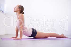 Yoga helps to quieten the chaos. An attractive young woman in a cobra position.
