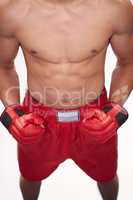 Built like a boxer. Cropped image of a young boxer in front of a white background.