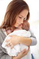 My precious little baby. Shot of a young mother holding her newborn baby girl in her arms.