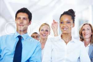 I have a question. Portrait of business woman raising her hand to ask question during seminar.