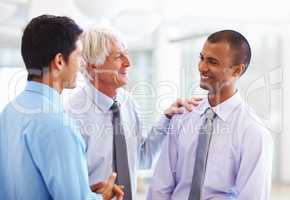 Business men having happy discussion. Portrait of business men having happy time while discussing with each other.