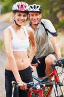 Biking pair. Portrait of a healthy sporting couple going for a bike ride together.