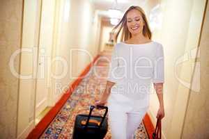 She stays at the finest hotels. Shot of an attractive young woman arriving at her hotel suite.
