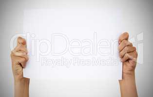Its yours to do with as you please. Studio shot of an unrecognisable woman holding up a blank sign against a grey background.
