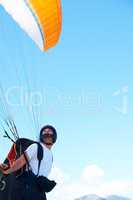 Spread your wings and fly. Shot of a man paragliding on a sunny day.