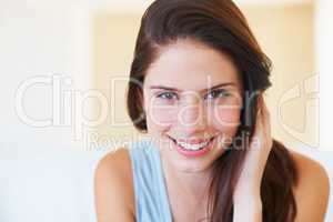 She has a sweet quality about her. A naturally beautiful young woman smiling at you.