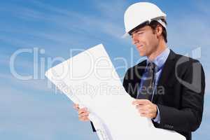 Smart architect looking at a new construction plan. Portrait of smart architect looking at a construction plan.