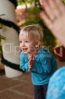 Learning the ways of tradition. Cute little boy adorned with a bindi on his forehead, bowing in a Hindu temple.