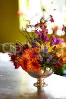 Flowers in a vase. Shot of a colourful arrangement of fresh flowers in a silver vase.