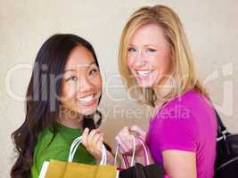 Friends and consumers. Portrait of a two happy young woman on a shopping spree.