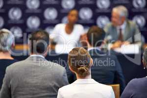 Giving their statement to the public. Shot of a group of businesspeople in a press conference.