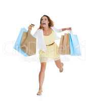 Impulse shopping. Full length studio shot of a frantic-looking woman carrying many shopping bags and running.