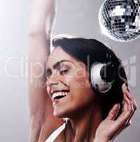 Dancing under a disco ball. Cropped shot of an attractive young woman dancing with total freedom.