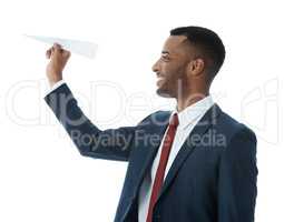 Doing business his own way. A businessman holding a folded paper plane while isolated on white.