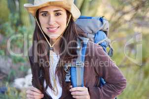 Fresh air at its best. A gorgeous young woman hiking with her backpack.