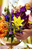 Bouquet of beauty. Closeup shot of a florists hands arranging a colourful bouqet.