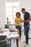 Which one do you like best. Shot of coworkers having an informal meeting with a laptop in a modern office.