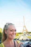 Paris is amazing. Portrait of a beautiful young woman taking photos while sight seeing in the Paris.