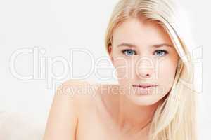 Blonde beauty. A beautiful young blonde woman with bare shoulders looking at the camera - copyspace.