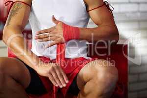 Pre-fight preparation. Cropped image of a young fighter wrapping his hands.