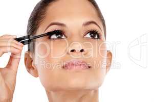 Luscious lashes. Attractive young woman applying mascara to her eyelashes.