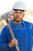 Excavator. Portrait of a construction worker with his shovel over his shoulder.