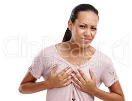 Theyre really sore today. Portrait of an attractive young woman clutching her chest in discomfort isolated on white.